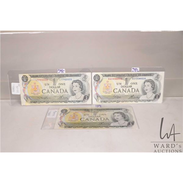 Three Canadian 1973 one dollar bills, all with good poker hands
