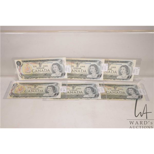 Six 1973 Canadian $1 bills including three with consecutive serial numbers