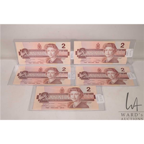 Five 1986 Canadian $2 bills with consecutive serial numbers