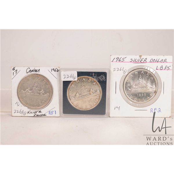 Three Canadian silver dollars including 1952, 1960 and 1965