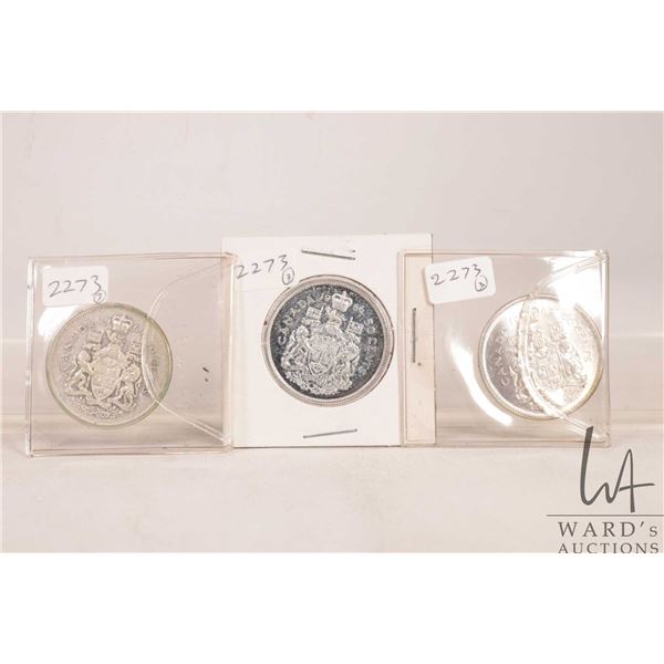 Three fifty cent Canadian coins including 1964, 1965 and 1966
