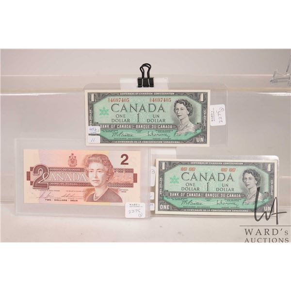 Two 1967 Canadian one dollar bills one with serial number and one with confederation dates plus a 19
