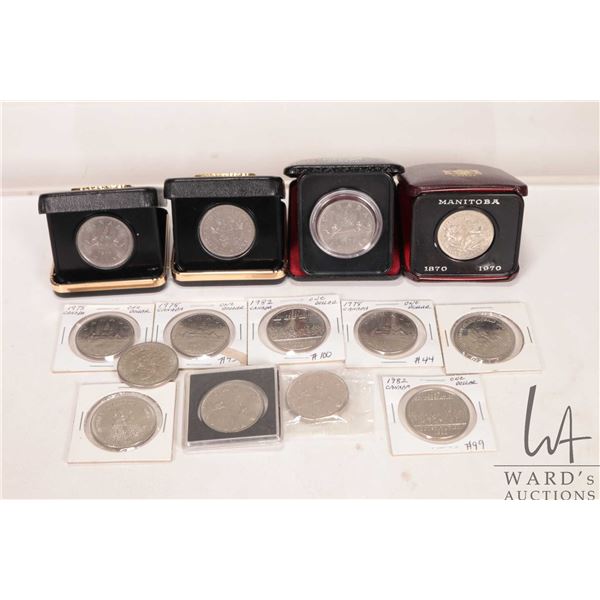 Twelve Canadian one dollar coins dates from 1960 through 1982 plus two medallions