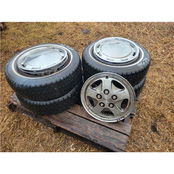 4- 175/70R13 tires c/w rims & caps. Located: Southside of locomotive cover