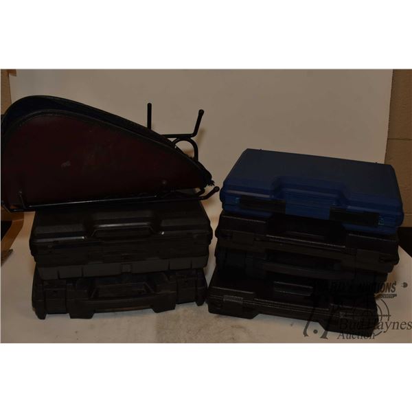 Seven hard pistol cases, one soft pistol case, a pistol display rack and a Pelican case