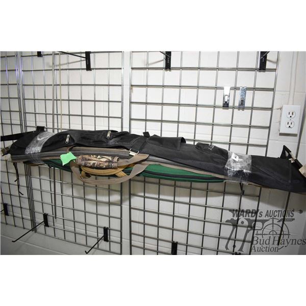 Two soft rifle cases, one rifle sock and a hanging storage bin