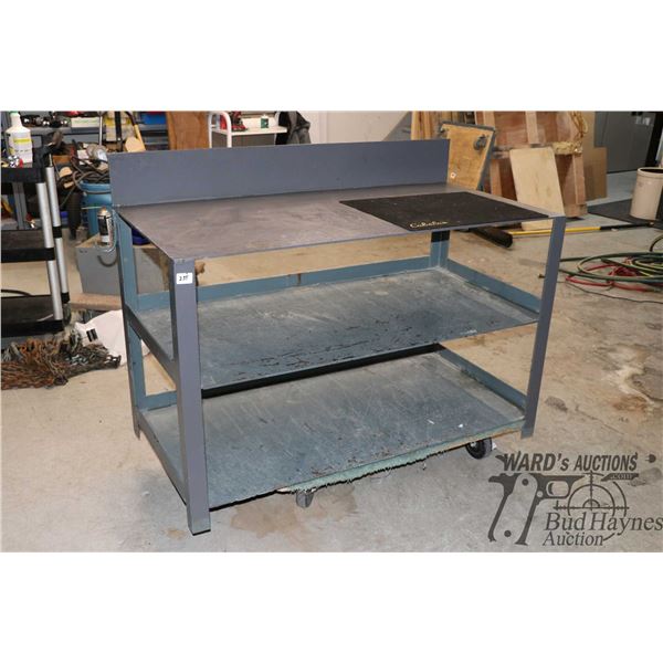 Heavy metal work station w/ two shelves measuring 36" H at back board, 48 1/2" W and 24" D