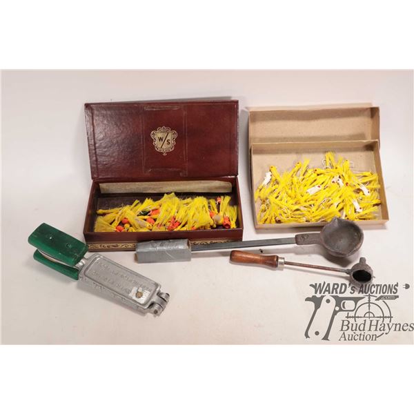 Large supple of molded jig heads with hooks, a mold for making jig heads and two ladles