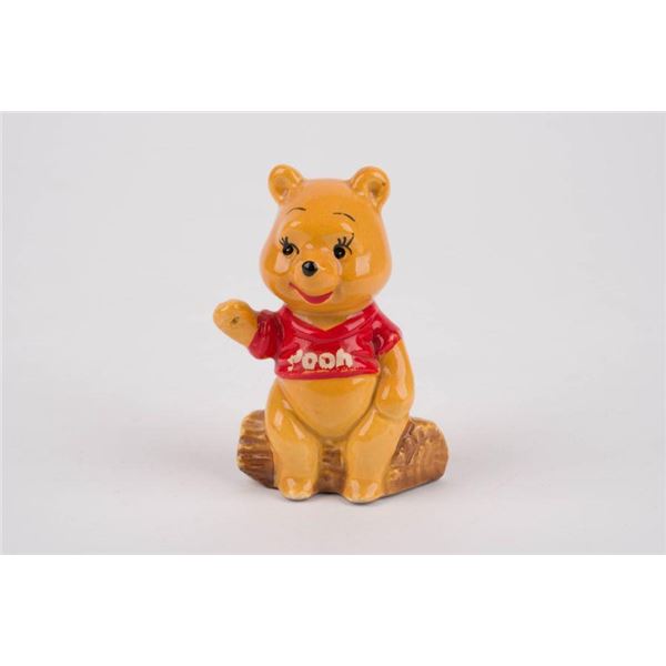 A Winnie the Pooh Figurine by Enesco.