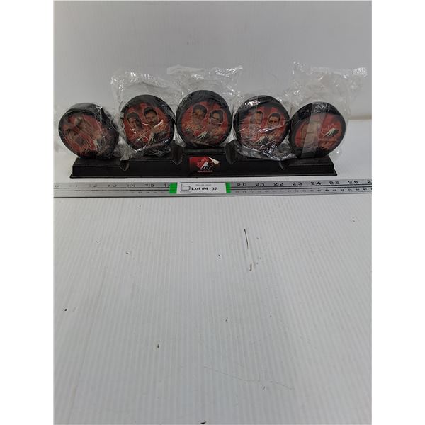 Collection of (6) Team Canada Pucks on Stand from 2012