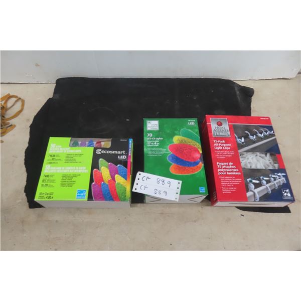 Two Boxes New LED Christmas Lights And One Box Of Hanging Clips