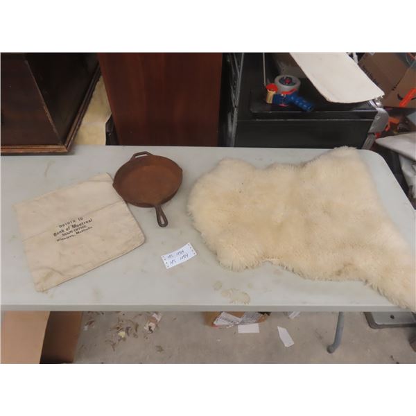 10" Lodge Cast-Iron Fry Pan (#3); 30" X 22" Sheepskin Rug; Bank of Montreal Money Bag