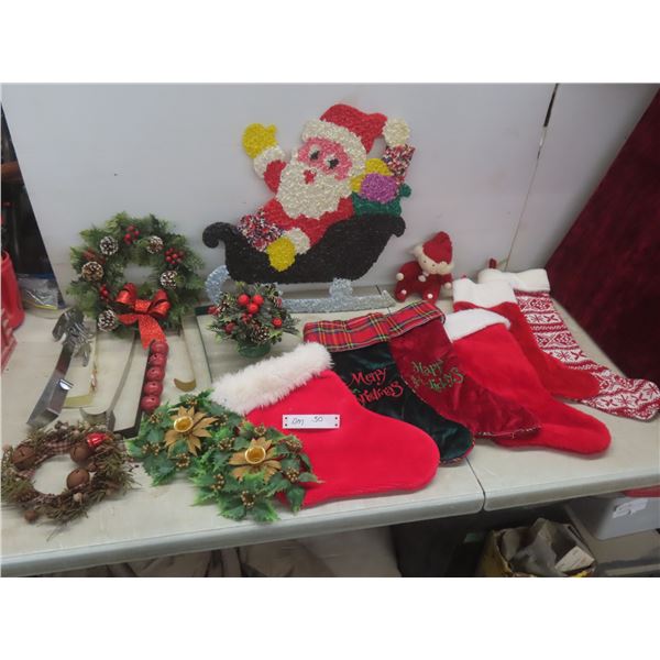 Christmas Décor Lot Including Stockings, Wreath, Vintage Plastic Popcorn Santa, and Candle Holders