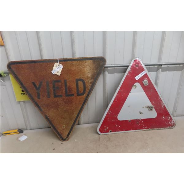 Two Yellow Signs Including One Older Sign