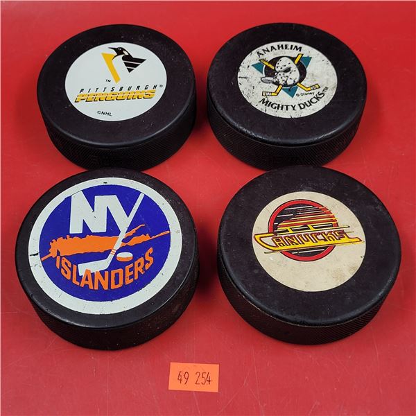 4 NHL Team Hockey Pucks w/ Mighty Ducks, Canucks, Penguins, & Islanders