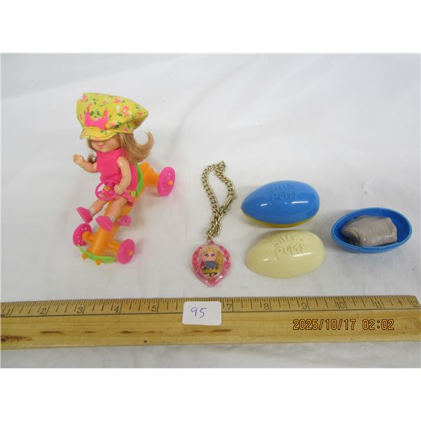 Lotof Toys Girl Riding Bike Necklace,2 Unused Containers of Silly Putty Circa 1970's