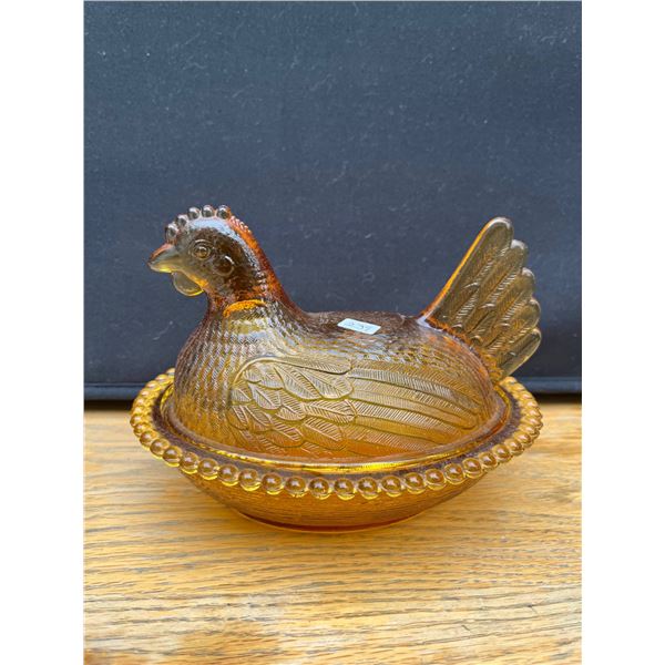 Vintage yellow hen on a nest