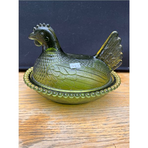 Vintage green hen on a nest