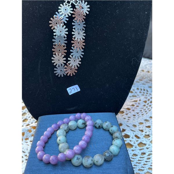 2 stone bracelets and 1 metal design bracelet