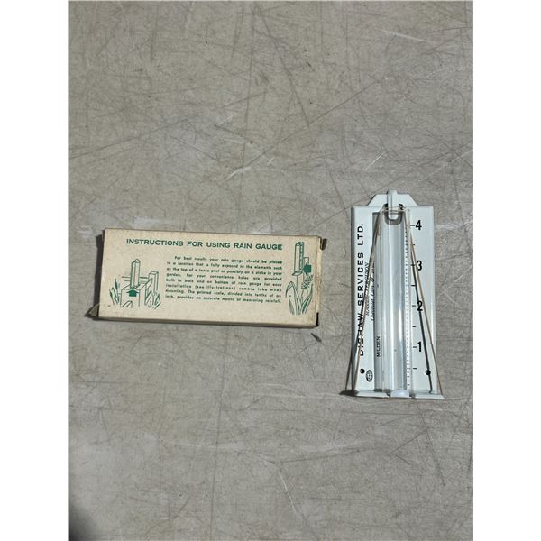 Massey Ferguson metal rain gauge (Dishaw services LTD.) Milden Saskatchewan