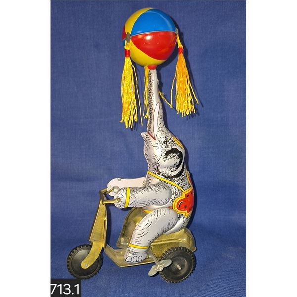 Windup tin lithographed Shylling circus elephant toy - works, drives while top rotates