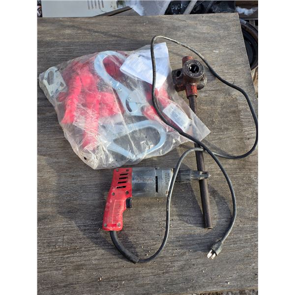 Harness, corded drill and pipe
