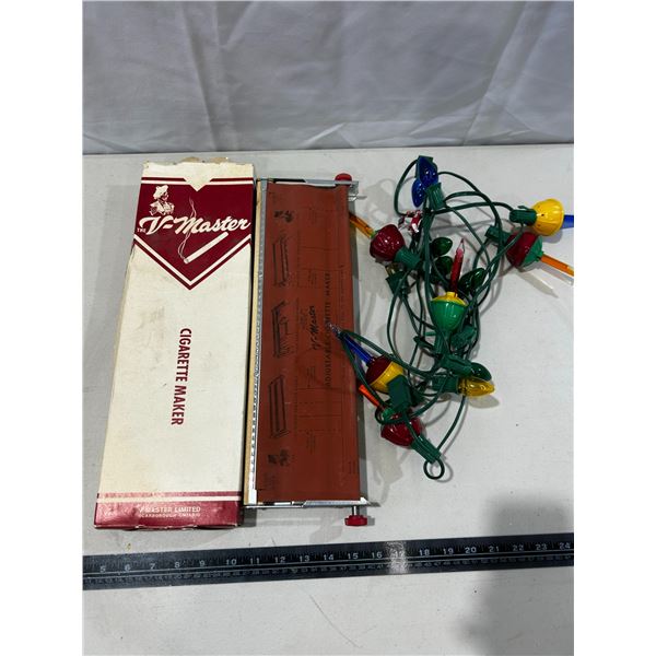 Vintage cigarette maker and string of Christmas lights