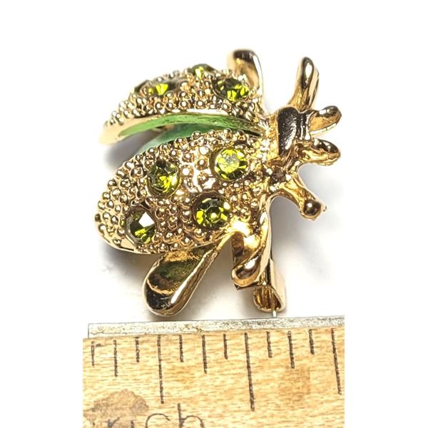 25)  GOLD TONE WITH GREEN CRYSTALS & STONE