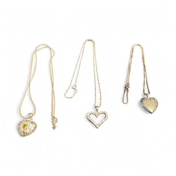 3 Sterling Silver Heart Necklaces - 1 Locket, 1 Avon with topaz center, and 1 white topaz open heart