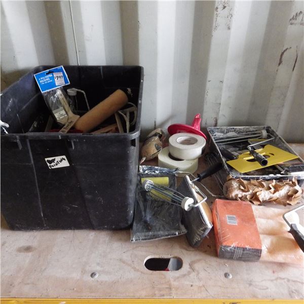 container with paint rollers and painting supplies