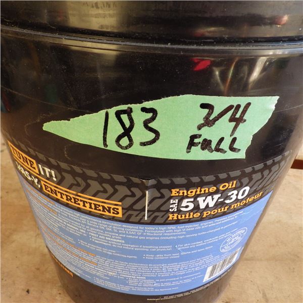 Pail approximately three quarters full of 5 W - 30 engine oil