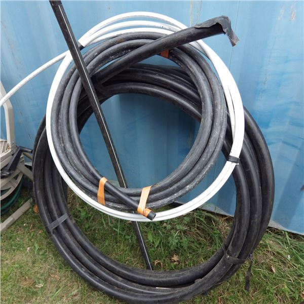 assorted rolls of plastic water hose