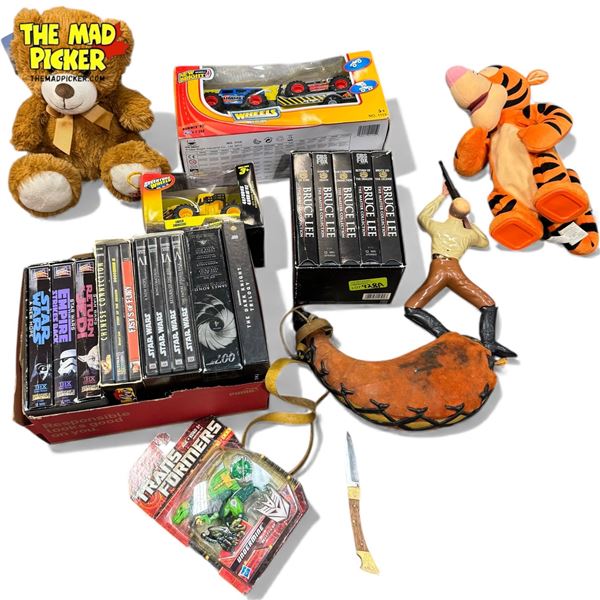 Milk Crate Of Assorted Collectibles, Vhs Tapes, Water Canteen, Transformer, Adventure Wheels, Etc