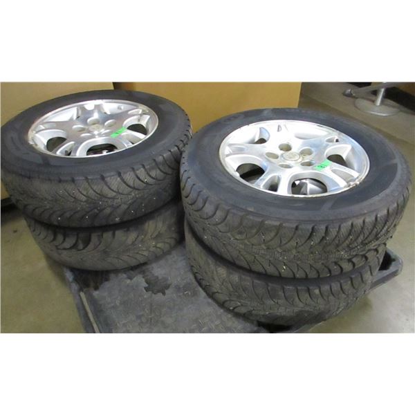 4 - 215/65R16 GOODYEAR ULTRA GRIP ICE TIRES (APPROX. 70% LEFT ON RAM MAG WHEELS)