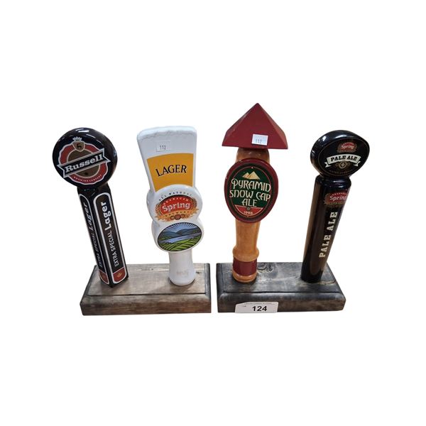 4 vintage beer tap handles on stands