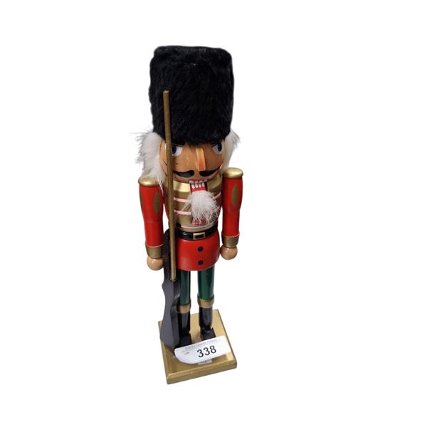 Large wood nutcracker holding rifle 14.5" tall
