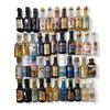 Image 1 : 50 Miniature Empty Liquor Bottles - Featuring Brands such as Bacardi, Captain Morgan, and Harveys