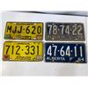 Image 1 : Group of four vintage Alberta license plates including two yellow commercial-style plates with regis
