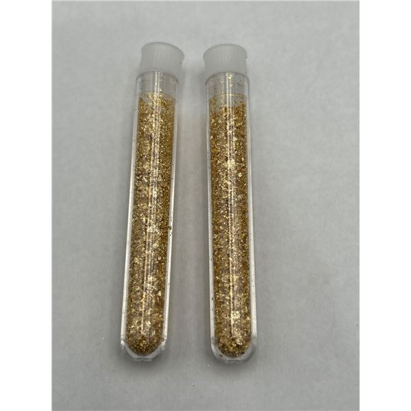 Two Transparent Plastic Tubes Containing Gold-Colored Flake Material