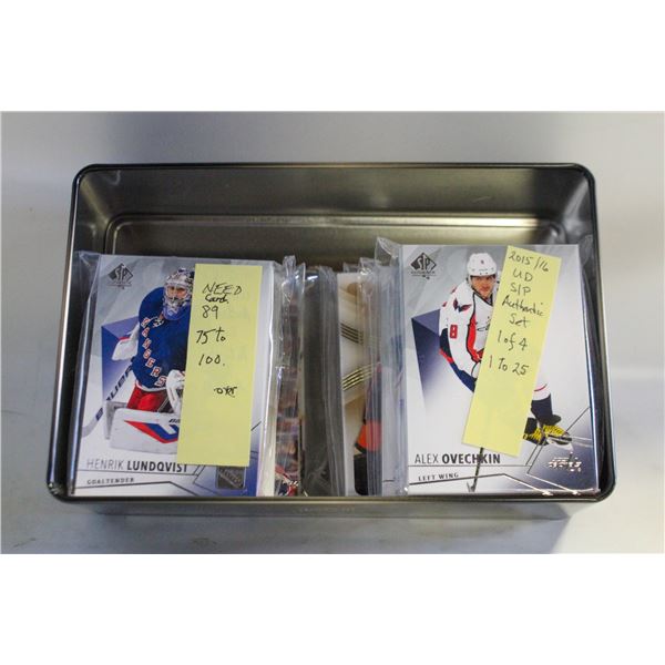 TIN FULL OF OPENED CARDS