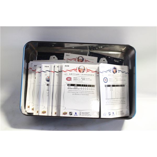 TIN FULL OF OPENED CARDS