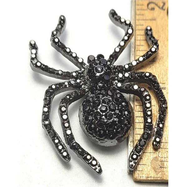 23)  BLACK CRYSTAL SPIDER BROOCH.