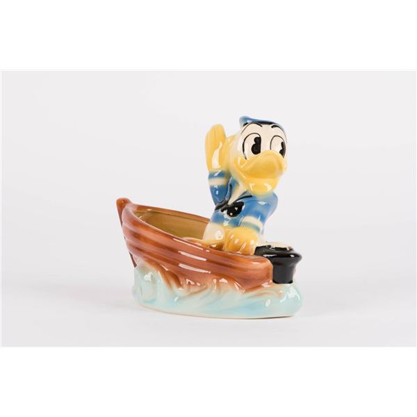 A 1940s Donald Duck Sailboat Ceramic Planter.