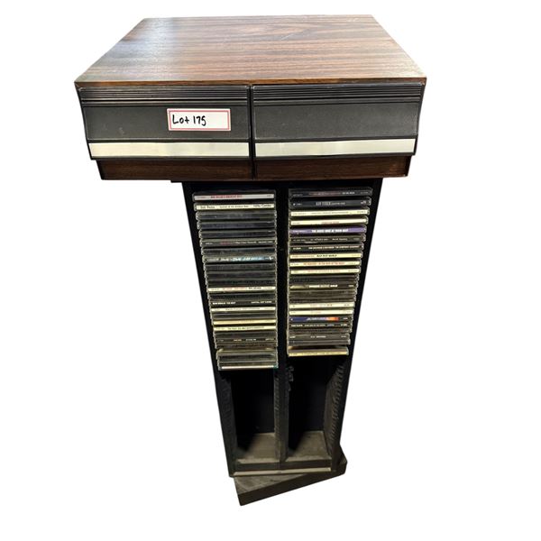 VHS tape collection in woodgrain storage case w/ CD collection on black media shelf - approx 41" H