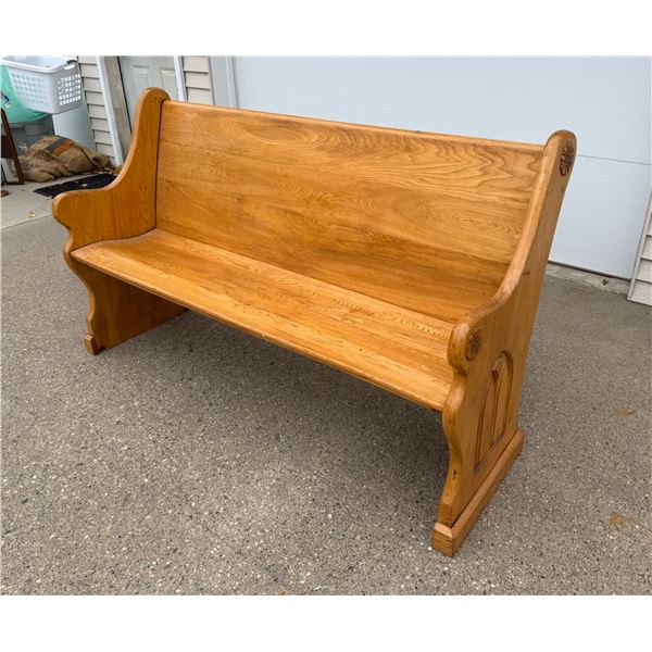 WOODEN PEW WITH A "CATHEDRAL WINDOW" ARCH AND FLOWERS CARVED INTO EACH END