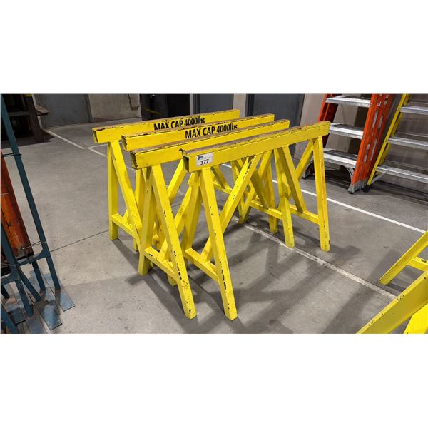 GROUP OF 4 YELLOW METAL HEAVY DUTY SAW HORSES APPROX 4' L X 3' H