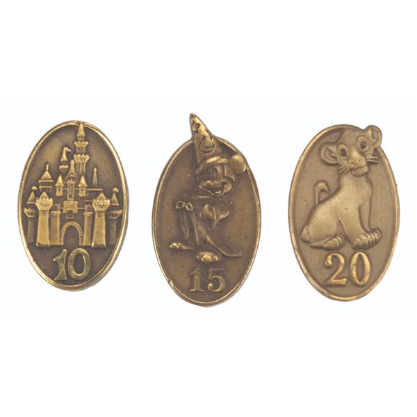 Three Cast Member Service Award Pins.