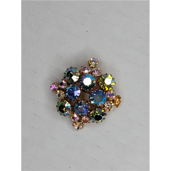 Colourful brooch missing stone