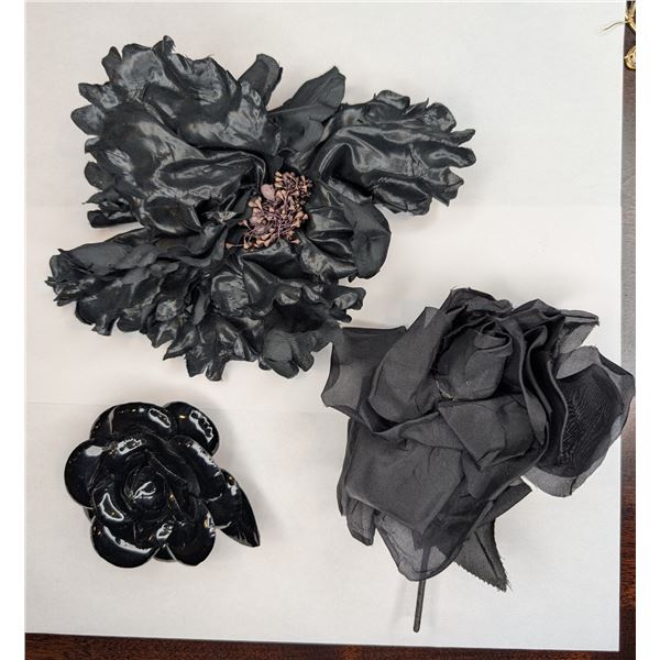 Three black lapel pins