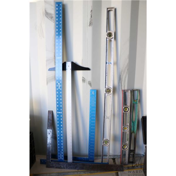 Assorted measuring tools including drywall squares roofing squares plus levels and a ruler